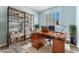 Bright home office with shelving, wood desk, and stylish decor elements at 2268 Alanhurst Dr, Henderson, NV 89052