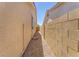 Narrow side yard with gravel base, brick wall and landscaping at 2268 Alanhurst Dr, Henderson, NV 89052