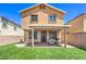 Spacious backyard with artificial grass, a covered patio, and a charming seating area at 2293 Sky Island Dr, Henderson, NV 89002