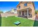Backyard showcasing a well-maintained lawn, a covered patio, and an outdoor seating area at 2293 Sky Island Dr, Henderson, NV 89002