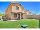 Inviting backyard featuring artificial turf, a patio, and outdoor seating area at 2293 Sky Island Dr, Henderson, NV 89002