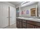 Spacious bathroom with dual sinks, granite countertops, and a large mirror with ample lighting at 2293 Sky Island Dr, Henderson, NV 89002