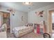 Charming bedroom with floral wall decor, a single bed, and a tidy, inviting space at 2293 Sky Island Dr, Henderson, NV 89002