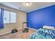 Bedroom featuring a blue accent wall, carpet floors, and a window providing natural light at 2293 Sky Island Dr, Henderson, NV 89002