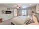 Inviting bedroom featuring a plush bed, ceiling fan, wall-mounted TV, and access to the en-suite bathroom at 2293 Sky Island Dr, Henderson, NV 89002