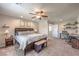 Spacious bedroom with ceiling fan, neutral color scheme, and adjacent home office area for work or study at 2293 Sky Island Dr, Henderson, NV 89002
