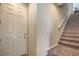 Bright entry hallway featuring a carpeted staircase and a white front door at 2293 Sky Island Dr, Henderson, NV 89002