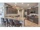 Stylish kitchen featuring dark wood cabinetry, granite countertops, stainless steel appliances, and breakfast bar seating at 2293 Sky Island Dr, Henderson, NV 89002