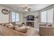 Comfortable living room with plush furniture, a ceiling fan, and bright windows at 2293 Sky Island Dr, Henderson, NV 89002