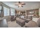 Open concept living room with plush furniture and view to the kitchen at 2293 Sky Island Dr, Henderson, NV 89002