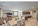 Open-concept living area with modern furnishings, tile flooring, and seamless flow to the kitchen and dining space at 2293 Sky Island Dr, Henderson, NV 89002