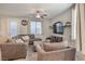 Comfortable living room with plush furniture, a ceiling fan, and bright windows at 2293 Sky Island Dr, Henderson, NV 89002
