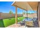 Covered patio featuring outdoor seating and a view of the well-manicured backyard at 2293 Sky Island Dr, Henderson, NV 89002