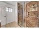 Bathroom boasts a marble shower with a glass door, tiled floors, and a single sink at 2398 S Lamont St, Las Vegas, NV 89104