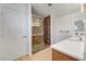 Bathroom features a marble-tiled shower with glass doors, and a single sink at 2398 S Lamont St, Las Vegas, NV 89104