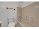 Bathroom features a toilet, towel bar and shower-tub combo with updated fixtures at 2398 S Lamont St, Las Vegas, NV 89104