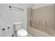 Bathroom featuring a tub with a shower and a toilet with white tile flooring at 2398 S Lamont St, Las Vegas, NV 89104
