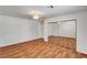 Spacious bedroom features wood-look flooring, ceiling fan, and mirrored closet doors at 2398 S Lamont St, Las Vegas, NV 89104