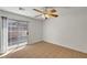Bright bedroom featuring tiled floors, a ceiling fan, and a sliding glass door at 2398 S Lamont St, Las Vegas, NV 89104