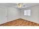 Bedroom with wood-look flooring, window with blinds and ceiling fan at 2398 S Lamont St, Las Vegas, NV 89104