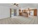 Open kitchen area features tile flooring, a sliding glass door, white appliances, and wood cabinets at 2398 S Lamont St, Las Vegas, NV 89104