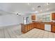 Open kitchen with granite counters, tile floors, wood cabinets, and stainless steel dishwasher at 2398 S Lamont St, Las Vegas, NV 89104