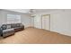 Living room with sliding door closets and a modern gray sofa set against tiled floors at 2398 S Lamont St, Las Vegas, NV 89104