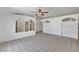 Open-concept living area featuring tile flooring, arched doorways, and built-in shelving at 2398 S Lamont St, Las Vegas, NV 89104