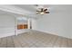 Bright living room featuring tiled floors, built-in shelving, arched doorways, and a ceiling fan at 2398 S Lamont St, Las Vegas, NV 89104