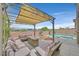 Beautiful backyard oasis featuring a covered lounge area, pool, and spa for ultimate relaxation at 2486 Dragon Fire Ln, Henderson, NV 89052