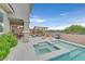 Inviting backyard with pool, spa, covered patio, and comfortable seating, perfect for outdoor entertainment at 2486 Dragon Fire Ln, Henderson, NV 89052