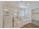Bathroom featuring a glass-enclosed shower and soaking tub, alongside a closet at 2486 Dragon Fire Ln, Henderson, NV 89052
