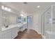 Bathroom with double sinks, shower, and tub, featuring modern fixtures and spacious layout at 2486 Dragon Fire Ln, Henderson, NV 89052