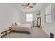 Cozy bedroom with ceiling fan, carpet floors, and natural light, with plants at 2486 Dragon Fire Ln, Henderson, NV 89052