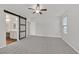 Spacious bedroom with carpet floors, barn door to bathroom, and ample natural light at 2486 Dragon Fire Ln, Henderson, NV 89052