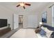 This staged bedroom has a view to the doorway, a double closet and tv at 2486 Dragon Fire Ln, Henderson, NV 89052
