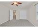 Bedroom with neutral paint and carpet, featuring a ceiling fan and closet at 2486 Dragon Fire Ln, Henderson, NV 89052