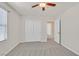 Bedroom with neutral paint and carpet, featuring a ceiling fan and closet at 2486 Dragon Fire Ln, Henderson, NV 89052