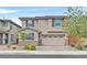Charming two-story home featuring a neutral stucco exterior, a two-car garage and meticulously kept landscaping at 2486 Dragon Fire Ln, Henderson, NV 89052