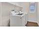 Laundry room featuring a washer, dryer, and overhead shelving at 2486 Dragon Fire Ln, Henderson, NV 89052