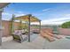 Relaxing patio area featuring comfortable seating under a pergola, ideal for enjoying the outdoors at 2486 Dragon Fire Ln, Henderson, NV 89052