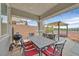 Inviting outdoor patio with grill, dining table, and pergola-covered lounge area perfect for entertaining at 2486 Dragon Fire Ln, Henderson, NV 89052