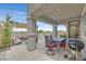 Spacious covered patio with outdoor dining area and lounge, perfect for entertaining or relaxing by the pool at 2486 Dragon Fire Ln, Henderson, NV 89052