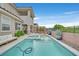 Expansive backyard featuring a refreshing pool, spa, covered patio, and lush landscaping for outdoor living at 2486 Dragon Fire Ln, Henderson, NV 89052