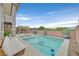 Inviting backyard oasis with pool, spa, and comfortable seating, perfect for outdoor relaxation and entertaining at 2486 Dragon Fire Ln, Henderson, NV 89052