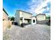 Home's backyard showcasing gravel landscaping, a covered patio, and block wall fence at 2749 Invermark St, Henderson, NV 89044