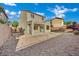 View of home's backyard with decorative rock landscaping and covered patio at 2749 Invermark St, Henderson, NV 89044