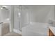 This is a bathroom featuring a soaking tub with white tile and a glass shower enclosure at 2749 Invermark St, Henderson, NV 89044
