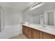 Bright bathroom featuring a double sink vanity, soaking tub, and a glass shower enclosure at 2749 Invermark St, Henderson, NV 89044
