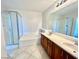 Bathroom featuring a tiled floor, a shower and bathtub combo, and a wooden vanity at 2749 Invermark St, Henderson, NV 89044